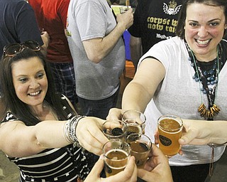 Leanne Nagle, left, of Beaver, Pa., and Kristi Williams of Beaver Falls, Pa., toast with friends during Big Tap In.