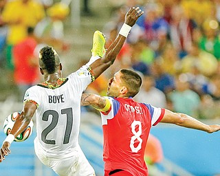 Ghana’s John Boye, left, challenges the United States’ Clint Dempsey for the ball during Monday’s World Cup match in Natal. USA won, 2-1.