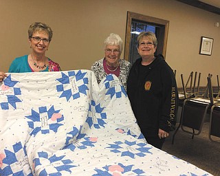 SPECIAL TO THE VINDICATOR: Ginger Mangie, left, president of That Quilt Group I Belong To of Canfield, recently presented a memory quilt to Julie Maruskin, center, recently retired owner of Quilter’s Quarters in Boardman. The quilt was made by Bev Sullivan, right, in honor of Maruskin’s 25 years in the quilting business.