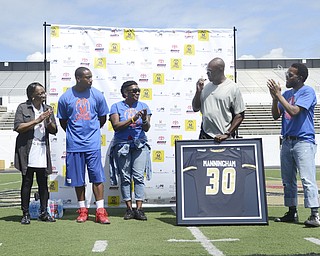 Katie Rickman | The Vindicator.Coach Arnold speaks during the jersey number retirement of Mario Manningham at Warren G. Harding June 21. From left to right: Anne Simpson (Mario's grandmother), Marion Manningham (Mario's mother), Mario Manningham, Coach Steven Arnold, and Kweisi Gharreau.