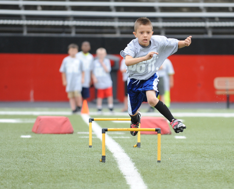 YOUNGSTOWN, OHIO - JUNE 21, 2014: Jordan Valdez clears a hurdle during the Brad Smith Football Camp at Stambaugh Stadium on the campus of Youngstown State Saturday morning. (Photo by David Dermer/Youngstown Vindicator)