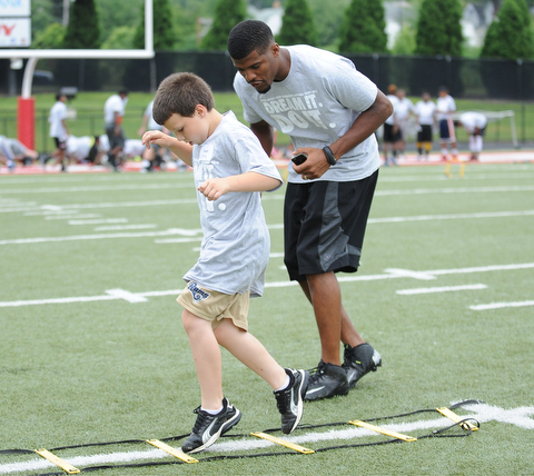 YOUNGSTOWN, OHIO - JUNE 21, 2014: Isaac Strock works on quick feet in a rope drill with Brad Smith next to him encouraging him during the Brad Smith Football Camp at Stambaugh Stadium on the campus of Youngstown State Saturday morning. (Photo by David Dermer/Youngstown Vindicator)