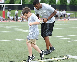 YOUNGSTOWN, OHIO - JUNE 21, 2014: Isaac Strock works on quick feet in a rope drill with Brad Smith next to him encouraging him during the Brad Smith Football Camp at Stambaugh Stadium on the campus of Youngstown State Saturday morning. (Photo by David Dermer/Youngstown Vindicator)