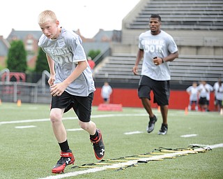 YOUNGSTOWN, OHIO - JUNE 21, 2014: Machael Johnson works on quick feet in a rope drill with Brad Smith next to him encouraging him during the Brad Smith Football Camp at Stambaugh Stadium on the campus of Youngstown State Saturday morning. (Photo by David Dermer/Youngstown Vindicator)
