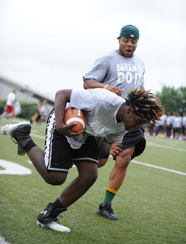 YOUNGSTOWN, OHIO - JUNE 21, 2014: Darrion Fant picks up the football to score while NFL player Tashard Choice encouraging him during the Brad Smith Football Camp at Stambaugh Stadium on the campus of Youngstown State Saturday morning. (Photo by David Dermer/Youngstown Vindicator)