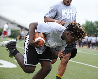 YOUNGSTOWN, OHIO - JUNE 21, 2014: Darrion Fant picks up the football to score while NFL player Tashard Choice encouraging him during the Brad Smith Football Camp at Stambaugh Stadium on the campus of Youngstown State Saturday morning. (Photo by David Dermer/Youngstown Vindicator)