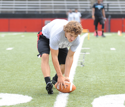 YOUNGSTOWN, OHIO - JUNE 21, 2014: Joey Zelinski picks up the football to score during the Brad Smith Football Camp at Stambaugh Stadium on the campus of Youngstown State Saturday morning. (Photo by David Dermer/Youngstown Vindicator)