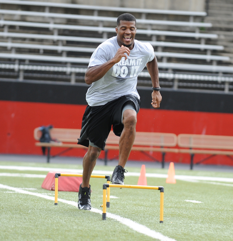 YOUNGSTOWN, OHIO - JUNE 21, 2014: Brad Smith clears a hurdle during a drill during the Brad Smith Football Camp at Stambaugh Stadium on the campus of Youngstown State Saturday morning. (Photo by David Dermer/Youngstown Vindicator)
