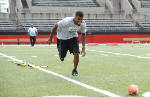 YOUNGSTOWN, OHIO - JUNE 21, 2014: Brad Smith runs to scoop up the football during a drill during the Brad Smith Football Camp at Stambaugh Stadium on the campus of Youngstown State Saturday morning. (Photo by David Dermer/Youngstown Vindicator)