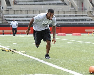 YOUNGSTOWN, OHIO - JUNE 21, 2014: Brad Smith runs to scoop up the football during a drill during the Brad Smith Football Camp at Stambaugh Stadium on the campus of Youngstown State Saturday morning. (Photo by David Dermer/Youngstown Vindicator)