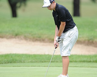 SALEM, OHIO - JUNE 23, 2014: Alec Hamilton of Austintown follows though on his putt  on the 18th hole on Monday afternoon at the Salem Golf Club during the Vindy Greatest Golfer tournament. (Photo by David Dermer/Youngstown Vindicator)