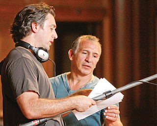 Director Jesse James Miller, left, works with Ray “Boom Boom” Mancini while shooting a segment Monday at the Ohio One Building downtown for the former boxing champ’s proposed reality TV show.