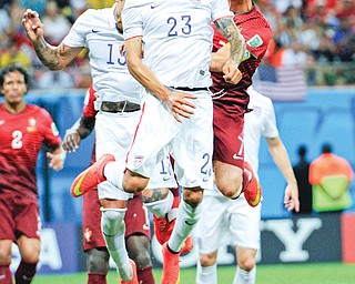The United States’ Fabian Johnson (23) heads the ball away from Portugal’s Cristiano Ronaldo, right, during the
group G World Cup soccer match between the USA and Portugal at the Arena da Amazonia in Manaus, Brazil, on
Sunday.