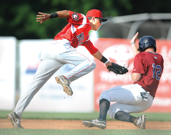 Muckdogs infielder Aaron Blanton attempts to tag Scrappers’ Austin Fisher during a steal attempt in second inning of Game 1 of their doubleheader Wednesday at Eastwood Field in Niles. The Scrappers won the early game, 5-0, but lost the nightcap, 4-1.