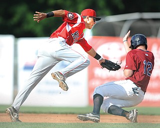 Muckdogs infielder Aaron Blanton attempts to tag Scrappers’ Austin Fisher during a steal attempt in second inning of Game 1 of their doubleheader Wednesday at Eastwood Field in Niles. The Scrappers won the early game, 5-0, but lost the nightcap, 4-1.