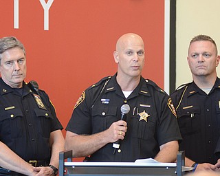 Mahoning County Sheriff Jerry Greene speaks as Canfield Police Chief Chuck Colucci looks on during Thursday
night’s sales-tax hearing at the Covelli Centre.