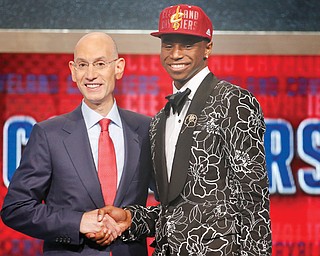 NBA Commissioner Adam Silver congratulates former Kansas forward Andrew Wiggins after Wiggins was selected as the No. 1 pick by the Cleveland Cavaliers in the 2014 NBA draft Thursday at The Barclays Center in Brooklyn, N.Y.