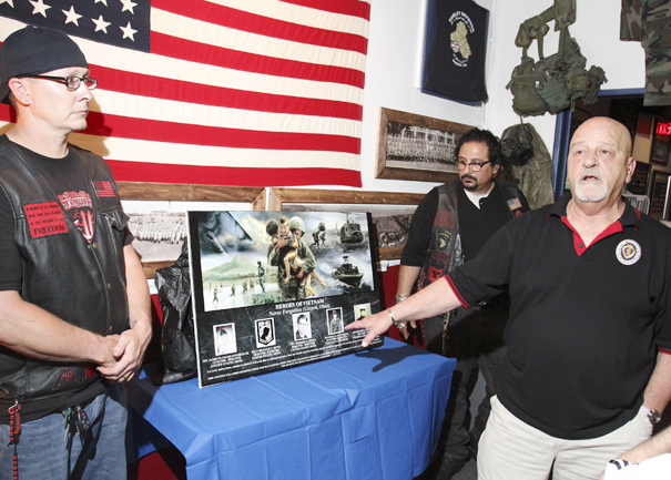 William d Lewis The Vindcaotr  Richard Watts of Girard speaks during a ceremony honoring 5 Girard men killed in Vietnam. At left is Landon McCauley, owner of Chestys Blue Collar Tavern in Girard where the event was held. At right is localartisit Ray Simon who created the artwork.