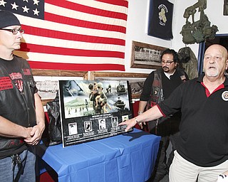 William d Lewis The Vindcaotr Richard Watts of Girard speaks during a ceremony honoring 5 Girard men killed in Vietnam. At left is Landon McCauley, owner of Chestys Blue Collar Tavern in Girard where the event was held. At right is localartisit Ray Simon who created the artwork.