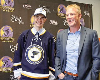 St. Louis Blues draftee Max Letunov poses with Troy Loney, part owner of the Youngstown Phantoms, during a press conference today at the Covelli Centre.