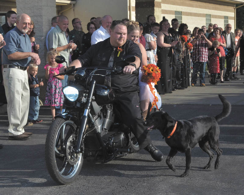 Bill and Julie Taylor on their wedding day at the Byzantine Center at the Grove in Youngstown. Their dog, Bubba, wasn't going to be left out. He was part of the ceremony, greeted guests and joined the couple at the table and on the dance floor, and pranced beside the bike afterward. Sent by Julie's sister, Sarah Hoefert. The couple live in New Middletown.