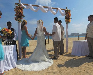 Wendy Fisher sent this of her special day, Aug. 9, 2013, in Cabo San Lucas, Mexico. The minister had them all hold hands and he blessed them as a family, from left to right, Melissa Bayus of Columbus, maid of honor; Allie Baklarz, Wendy's daughter; the bride; her husband, Jaison Fisher; the bride's son, Krystopher Baklarz, all of Boardman; and the best man and groom's brother, Jeff Fisher of Uniontown, Pa.