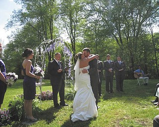 Allyson Rust-1: Sharing their first kiss as husband and wife are Allyson and Luke Rust. The outside wedding took place in front a house built in the 1800s in Mercer, Pa., and the reception followed in the barn in the back yard. The couple made and set up all the decorations, which made the day more meaningful to them.