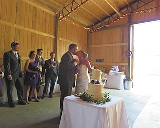Mr. and Mrs. Luke Rust sharing a kiss at their reception.