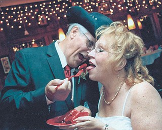 Marshall and Christine Blaire are sharing a piece of their "Red Solo Cup" cake at their wedding, Sept. 15, 2012. They met online Feb. 18, 2012.