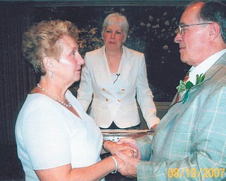 Don and June Hoelzel of Poland with the Rev. Ann Miller at their wedding Aug. 19, 2007. They met at the Canfield Fair in 2006 while both were volunteering.