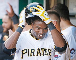 The Pirates’ Gregory Polanco celebrates with teammates in the dugout after hitting a two-run home run off
Diamondbacks starting pitcher Chase Anderson during the second inning of their game Wednesday in Pittsburgh.