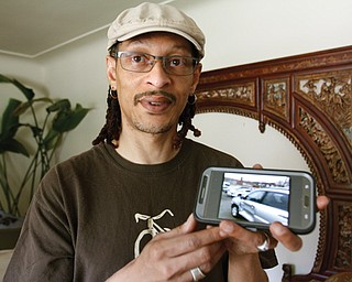 Robert Matthews, a Youngstown hairdresser, shows a picture of his car, which was broadsided last November, causing his head to strike the window, a blow that he believes caused a brain tumor at the base of his skull to grow and require surgery. In March, he underwent a relatively new through-the-nose technique at Cleveland Clinic to have the tumor removed.
