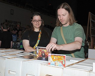 Eric Harper and Julie Cancio-Harper, both of Boardman, look through stacks of comic books at the fifth annual comic-book convention. 
