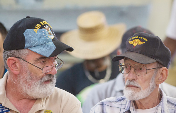Vietnam veteran Gene Stoesser, right, talks with Veterans Crisis Command Center volunteer Chuck Lewi while he waits for an appointment at American Legion Post 1 in Phoenix.
