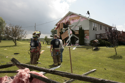        ROBERT K. YOSAY  | THE VINDICATOR...A house had its roofing blown off and a side wall blown out by the storm on 9000 block of Canfield Akron Rd (224) .a small structure of the neighbors used for students waiting on a bus was destroyed ...  -30-