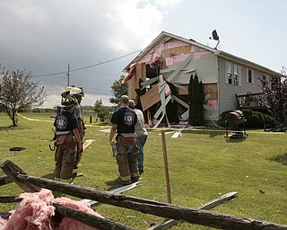       ROBERT K. YOSAY  | THE VINDICATOR...A house had its roofing blown off and a side wall blown out by the storm on 9000 block of Canfield Akron Rd (224) .a small structure of the neighbors used for students waiting on a bus was destroyed ...  -30-