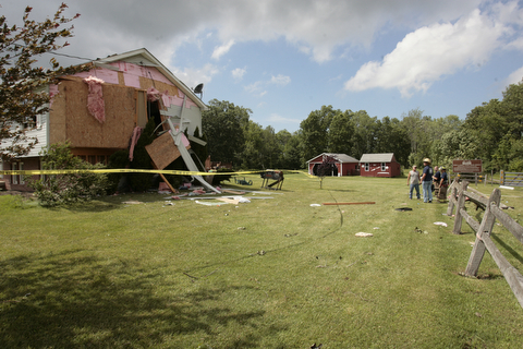        ROBERT K. YOSAY  | THE VINDICATOR...A house had its roofing blown off and a side wall blown out by the storm on 9000 block of Canfield Akron Rd (224) .a small structure of the neighbors used for students waiting on a bus was destroyed ...  -30-