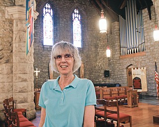 Top, 10 circular clerestory stained-glass windows in St. John’s Episcopal Church in Youngstown depict elements of the Mahoning Valley’s steelmaking legacy. This window shows a riverboat bringing coal. Each window is associated with a Psalm; this one is Psalm 46:4. Liz Wrona?, above, a 30-year member of the church, organizes church tours. The church was added to the National Register of Historic Places in 2012. Tours are set for noon to 3 p.m. Saturday as part of the annual Summer Festival of the Arts sponsored by Youngstown State University.
