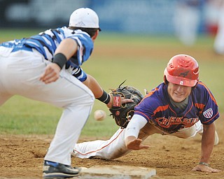 Gino DiVincenzo of Creekside Fitness dives for the base as the Ohio Glaciers’ Greg Popatak is unable to catch a throw by pitcher Matt Gordon on a pick-off attempt in the second inning of their Class B championship game Thursday at Cene Park in Struthers. The ball went into right field, and DiVincenzo advanced to third. Creekside shut out Glaciers, 3-0, to take the series 3-2 and win the title. 
