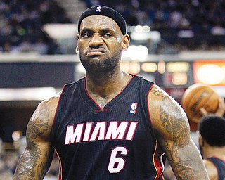 FILE PHOTO - In this Dec. 27, 2013 Heat forward LeBron James sneers after drawing a foul in a game against the Kings. While the wait continues for James to make a decision on where he’ll play this season, once-scorned Cleveland and a now-panicked Miami will undoubtedly feel alienated by whatever choice his latest foray into free agency leads him. 
