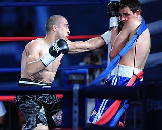 PITTSBURGH, PENNSYLVANIA - JULY 11, 2014: Jake Giuriceo throws a punch to the head of Travis Hartman during a welterweight bout Friday night at Rivers Casino. Giuriceo would win via 4th round TKO. (Photo by David Dermer/Youngstown Vindicator)