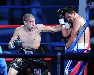 PITTSBURGH, PENNSYLVANIA - JULY 11, 2014: Jake Giuriceo winds up to throw a punch at Travis Hartman during a welterweight bout Friday night at Rivers Casino. Giuriceo would win via 4th round TKO. (Photo by David Dermer/Youngstown Vindicator)