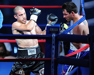 PITTSBURGH, PENNSYLVANIA - JULY 11, 2014: Jake Giuriceo follows through with a punch to the head of Travid Hartman during a welterweight bout Friday night at Rivers Casino. Giuriceo would win via 4th round TKO. (Photo by David Dermer/Youngstown Vindicator)