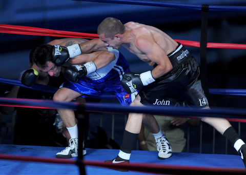 PITTSBURGH, PENNSYLVANIA - JULY 11, 2014: Jake Giuriceo connects with a punch to the head of Travis Hartman that would knock him down to the canvas during a welterweight bout Friday night at Rivers Casino. Giuriceo would win via 4th round TKO. (Photo by David Dermer/Youngstown Vindicator)