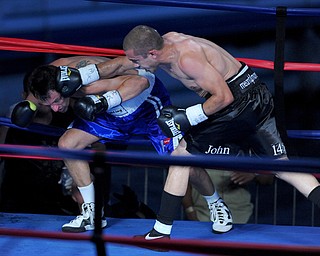 PITTSBURGH, PENNSYLVANIA - JULY 11, 2014: Jake Giuriceo connects with a punch to the head of Travis Hartman that would knock him down to the canvas during a welterweight bout Friday night at Rivers Casino. Giuriceo would win via 4th round TKO. (Photo by David Dermer/Youngstown Vindicator)