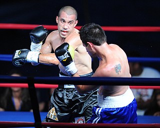 PITTSBURGH, PENNSYLVANIA - JULY 11, 2014: Jake Giuriceo follows through with a punch to the head of Travid Hartman during a welterweight bout Friday night at Rivers Casino. Giuriceo would win via 4th round TKO. (Photo by David Dermer/Youngstown Vindicator)