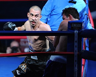 PITTSBURGH, PENNSYLVANIA - JULY 11, 2014: Jake Giuriceo winds up to throw a punch at Travis Hartman during a welterweight bout Friday night at Rivers Casino. Giuriceo would win via 4th round TKO. (Photo by David Dermer/Youngstown Vindicator)