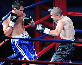 PITTSBURGH, PENNSYLVANIA - JULY 11, 2014: Jake Giuriceo looks for a opening to throw a punch at Travis Hartman during a welterweight bout Friday night at Rivers Casino. Giuriceo would win via 4th round TKO. (Photo by David Dermer/Youngstown Vindicator)