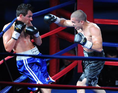 PITTSBURGH, PENNSYLVANIA - JULY 11, 2014: Jake Giuriceo throws a punch to the head of Travis Hartman during a welterweight bout Friday night at Rivers Casino. Giuriceo would win via 4th round TKO. (Photo by David Dermer/Youngstown Vindicator)