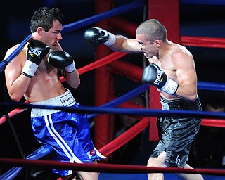 PITTSBURGH, PENNSYLVANIA - JULY 11, 2014: Jake Giuriceo throws a punch to the head of Travis Hartman during a welterweight bout Friday night at Rivers Casino. Giuriceo would win via 4th round TKO. (Photo by David Dermer/Youngstown Vindicator)